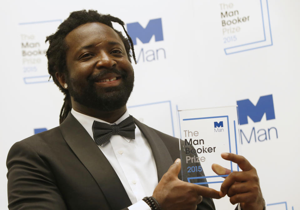 FILE - In this Oct. 13, 2015 file photo, Jamaican author Marlon James poses with the award after his book "A Brief History of Seven Killings," was named as winner of the 2015 Booker Prize 2015 for Fiction in London. Author of four novels, the 48-year-old James has made an art of “finding what would rather stay lost,” as he writes in his new work, “Black Leopard, Red Wolf.” (AP Photo/Alastair Grant, File)