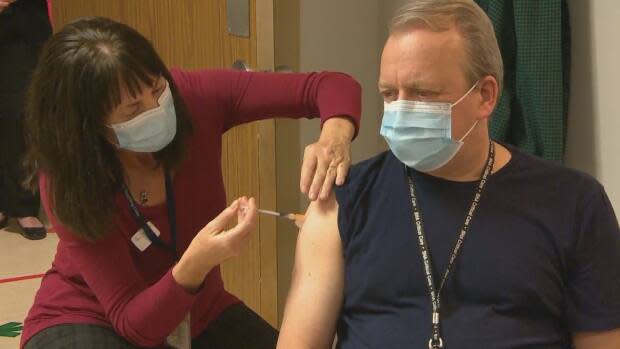 Dr. Jeffrey Betcher, right, was the very first person in Saskatchewan to be vaccinated against COVID-19. He is encouraging others in the province to help preserve the healthcare system and its workers, by getting the COVID-19 vaccine. 