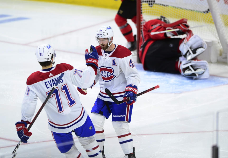 Montreal Canadiens' Paul Byron (41) celebrates a shorthanded goal on Ottawa Senators goalie Filip Gustavsson (32) with teammate Jake Evans (71) during the second period of an NHL hockey game Thursday, April 1, 2021, in Ottawa, Ontario. (Sean Kilpatrick/The Canadian Press via AP)