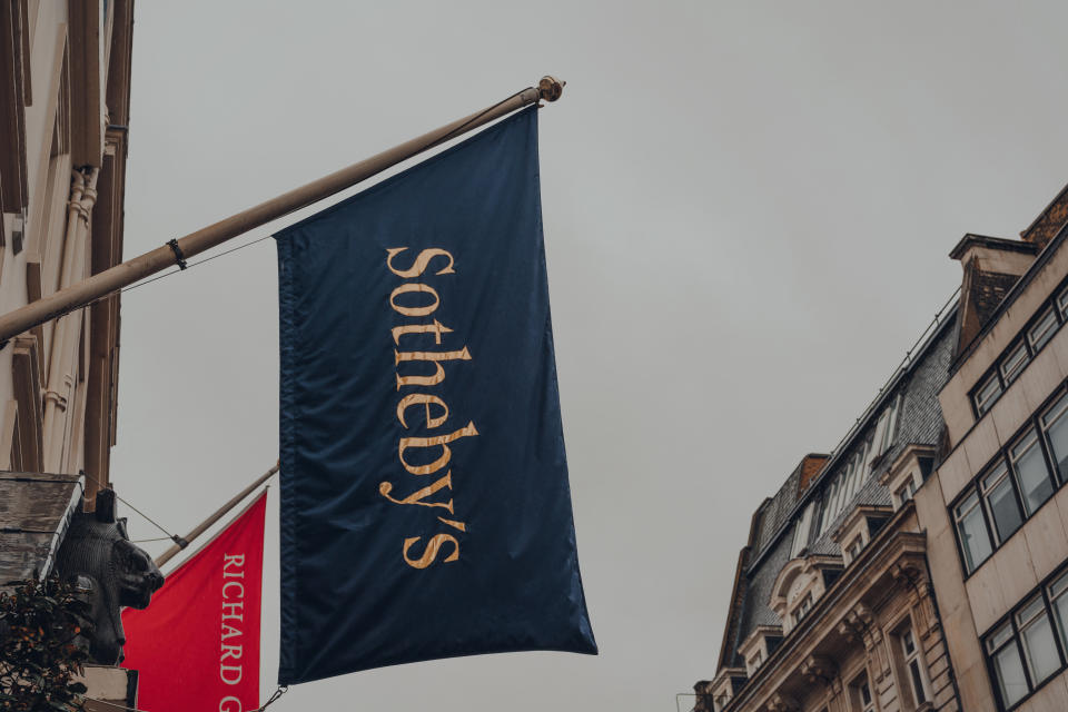 London, UK - October 02, 2021: Low angle view of the flag outside Sotheby's, one of the world's largest brokers of fine and decorative art, jewellery and collectibles, on New Bond Street in London.