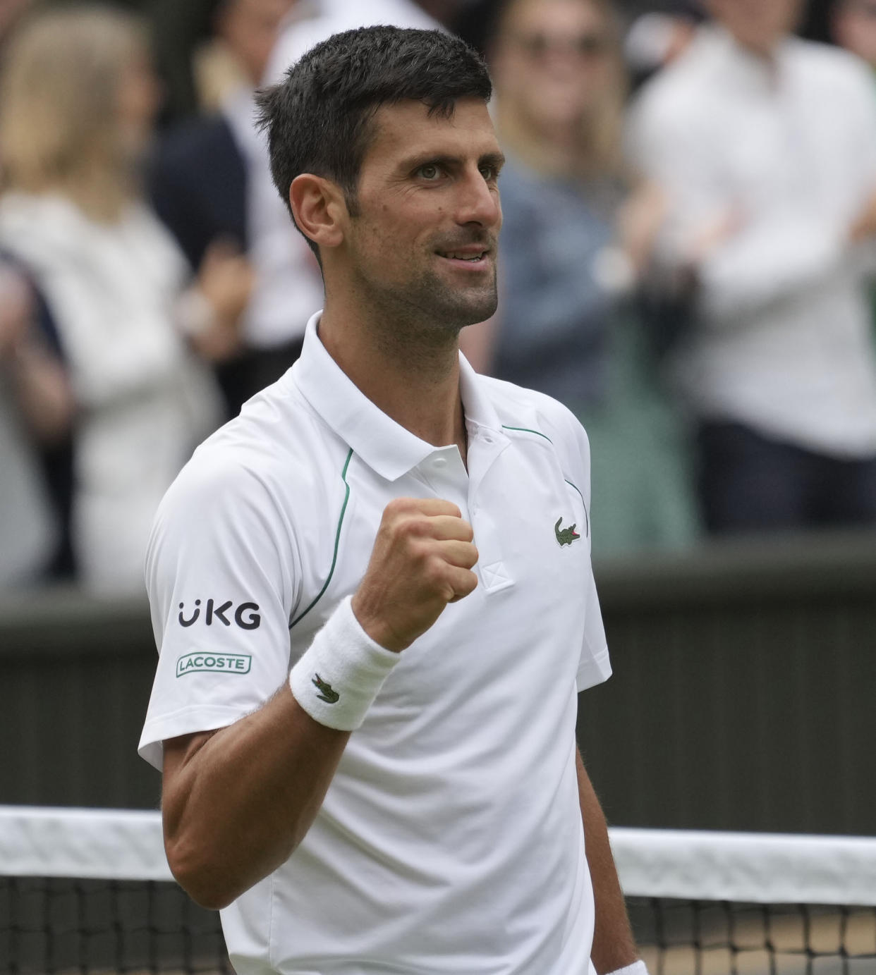 Serbia's Novak Djokovic celebrates after defeating Hungary's Marton Fucsovics during the men's singles quarterfinals match on day nine of the Wimbledon Tennis Championships in London, Wednesday, July 7, 2021. (AP Photo/Alberto Pezzali)