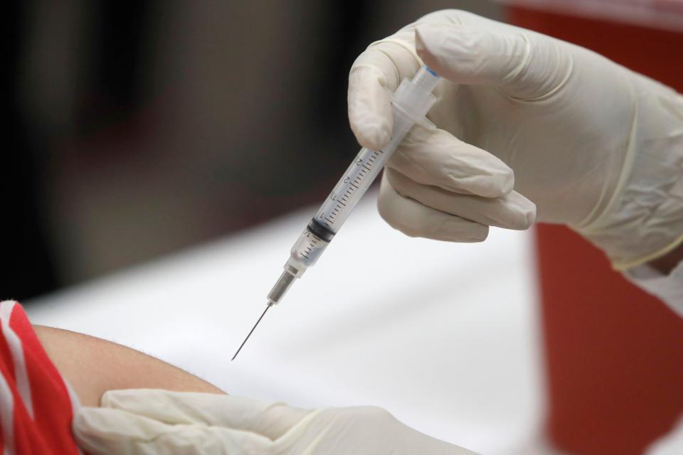 In this Thursday, Jan. 23, 2020, file photo, a patient receives an influenza vaccine in Mesquite, Texas.