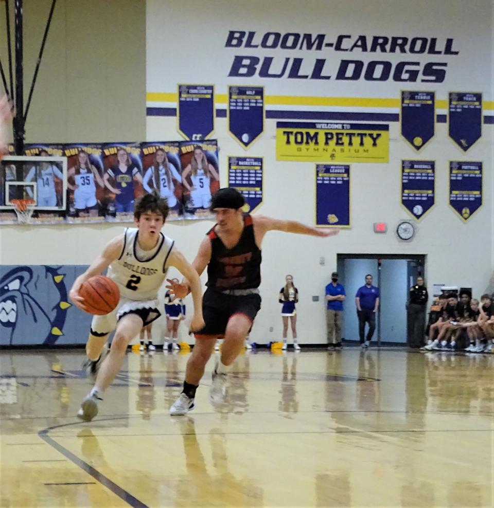 Bloom-Carroll sophomore point guard Jackson Wyant dribbles past Liberty Union's Landon Picirillo during the Bulldogs' 61-29 win Friday night.