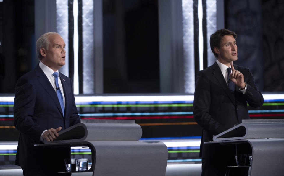 FILE - Conservative leader Erin O'Toole, left, and Liberal leader Justin Trudeau speak during the federal election French-language leaders debate, Wednesday, Sept. 8, 2021, in Gatineau, Que. Trudeau called the early election for Monday, Sept. 20 in hopes of winning a majority of seats in Parliament, but has faced criticism for calling a vote during a pandemic in order to cement his hold on power. (Justin Tang/The Canadian Press via AP)