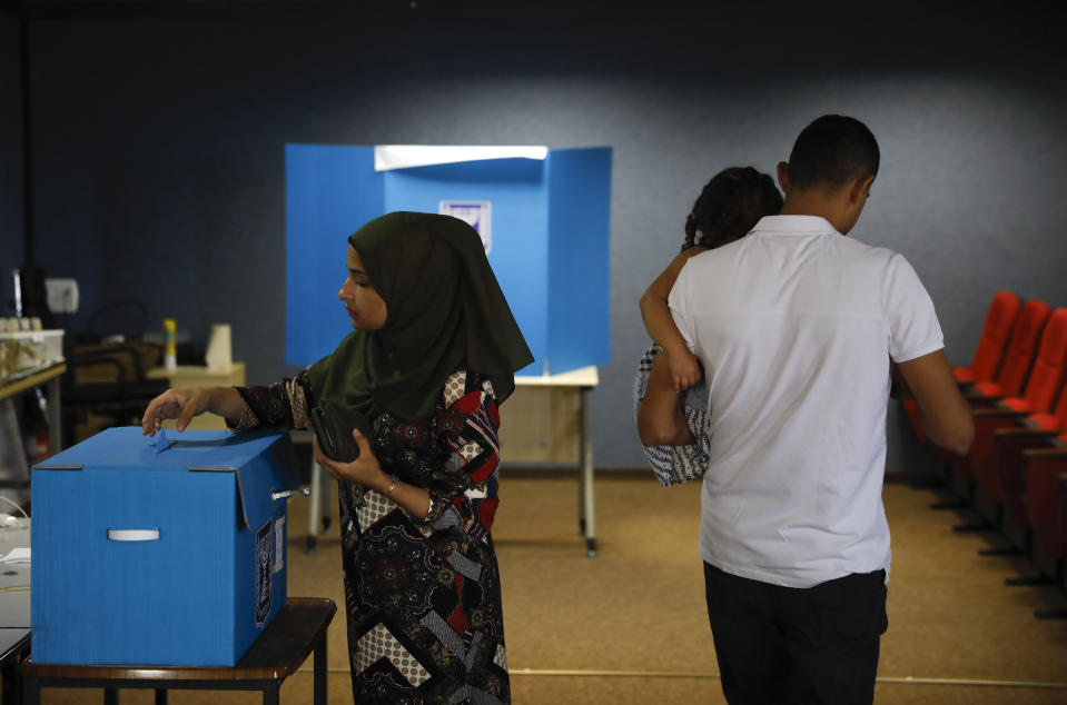 FILE - In this Sept. 17, 2019 file photo, a woman votes in Kfar Manda, an Arab town in Israel. Prime Minister Benjamin Netanyahu, who has spent much of his long career casting Israel's Arab minority as a potential fifth column led by terrorist sympathizers, is now openly courting their support as he seeks reelection in the country's fourth vote in less than two years. (AP Photo/Ariel Schalit, File)