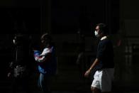 Pedestrians wear protective face masks amidst fears of the coronavirus disease (COVID-19) in Sydney