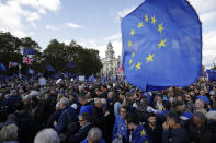 Anti-Brexit remain in the European Union supporters gather after taking part in a "People's Vote" protest march calling for another referendum on Britain's EU membership, in Parliament Square in London, Saturday, Oct. 19, 2019. Britain's Parliament is set to vote in a rare Saturday sitting on Prime Minister Boris Johnson's new deal with the European Union, a decisive moment in the prolonged bid to end the Brexit stalemate. Various scenarios may be put in motion by the vote. (AP Photo/Matt Dunham)