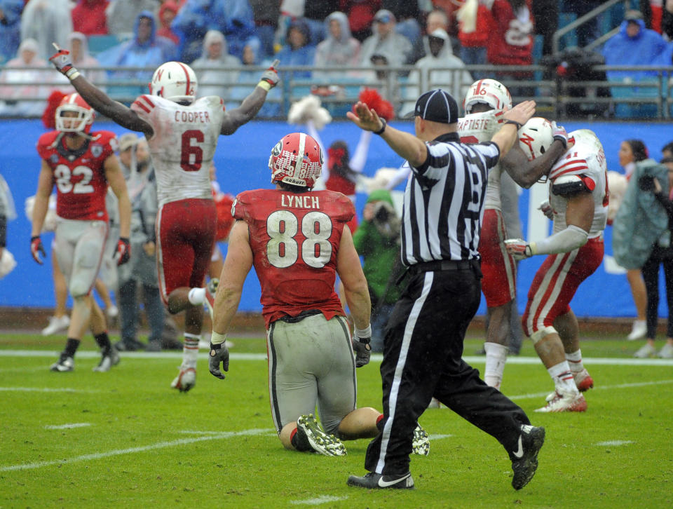 Nebraska safety Corey Cooper (6) celebrates a fourth down pass break up intended for Georgia tight end Arthur Lynch (88) in the final seconds of the second half of the Gator Bowl NCAA college football game, Wednesday, Jan. 1, 2014, in Jacksonville, Fla. (AP Photo/Stephen B. Morton)