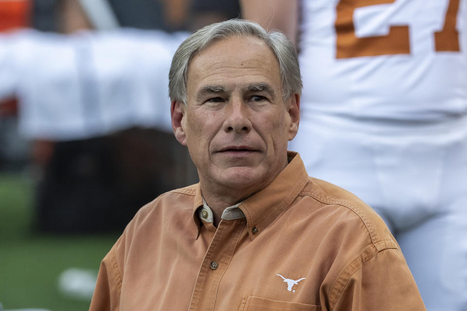 FILE - Texas Gov. Greg Abbott visits the field during warmups before an NCAA college football game between Texas and Alabama, Sept. 9, 2023, in Tuscaloosa, Ala. Abbott arrived in New York City to chat on Wednesday, Sept. 27, about the border crisis and the influx of migrants that has brought chaos to the city. He says he began busing migrants to New York and other cities to alleviate the pressure on border towns in his state. (AP Photo/Vasha Hunt, File)