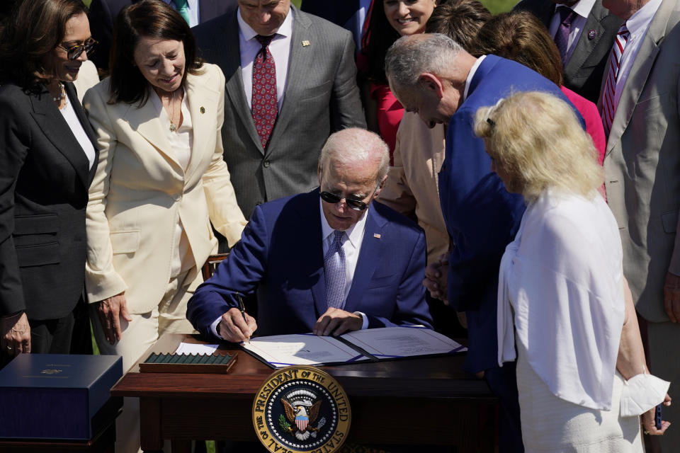 FILE - President Joe Biden signs into law H.R. 4346, the CHIPS and Science Act of 2022, at the White House in Washington, Aug. 9, 2022. (AP Photo/Carolyn Kaster, File)