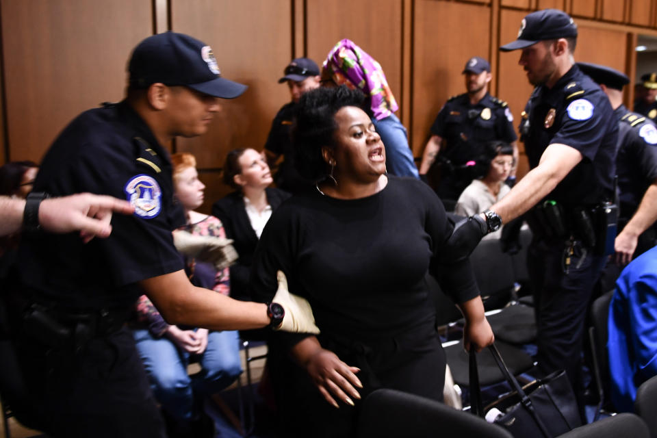 A protester is carried out during Brett Kavanaugh's confirmation hearing. (Photo: Brendan Smialowski/Getty Images)