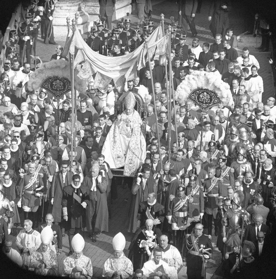 FILE - In this Oct. 11, 1962 file photo, Pope John XXIII is carried on his portable throne through a huge crowd gathered in St. Peter's Square, as the pontiff enters St. Peter's Basilica for the opening ceremonies of the Roman Catholic Ecumenical Council, in Vatican City. While much of the focus of Sunday's dual canonization will be on Pope John Paul II's globe-trotting, 26-year papacy and his near-record sprint to sainthood, many older Catholics will be celebrating the short but historic pontificate of the "Good Pope," John XXIII. (AP Photo/Girolamo Di Majo, File)