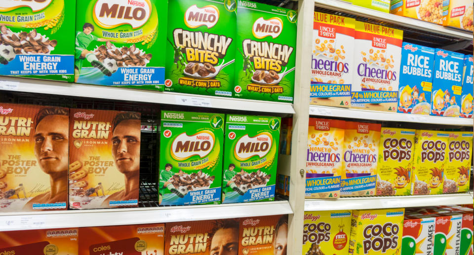 Cereal boxes on supermarket shelf.