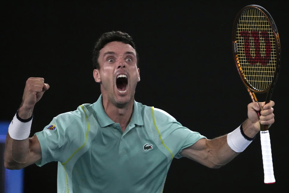 Roberto Bautista Agut of Spain celebrates after defeating Andy Murray of Britain in their third round match at the Australian Open tennis championship in Melbourne, Australia, Saturday, Jan. 21, 2023. (AP Photo/Ng Han Guan)