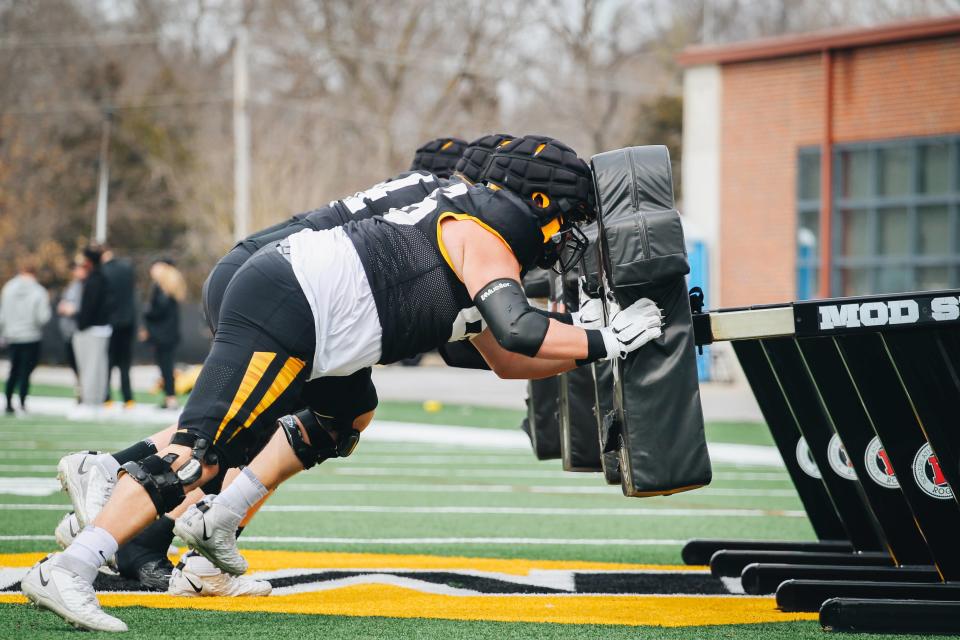 Missouri's offensive line pushes a sled during a drill at spring practice on March 8 at the Mizzou Athletic Training Complex.