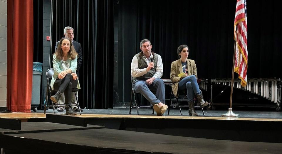 From left, Pataskala resident Eileen DeRolf, town hall moderator Michael McKenna (behind DeRolf), expert Nate Picarsic and expert Emily de La Bruyere during the Not In Our Town Townhall on Tuesday at Licking Heights Middle School.