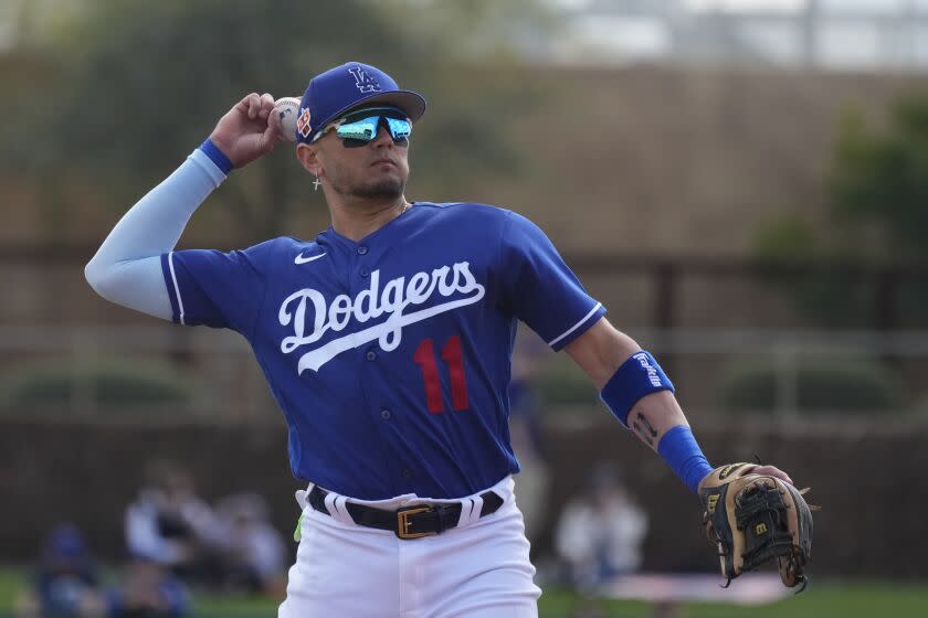 Dodgers shortstop Miguel Rojas warms up during the second inning of a spring training baseball game