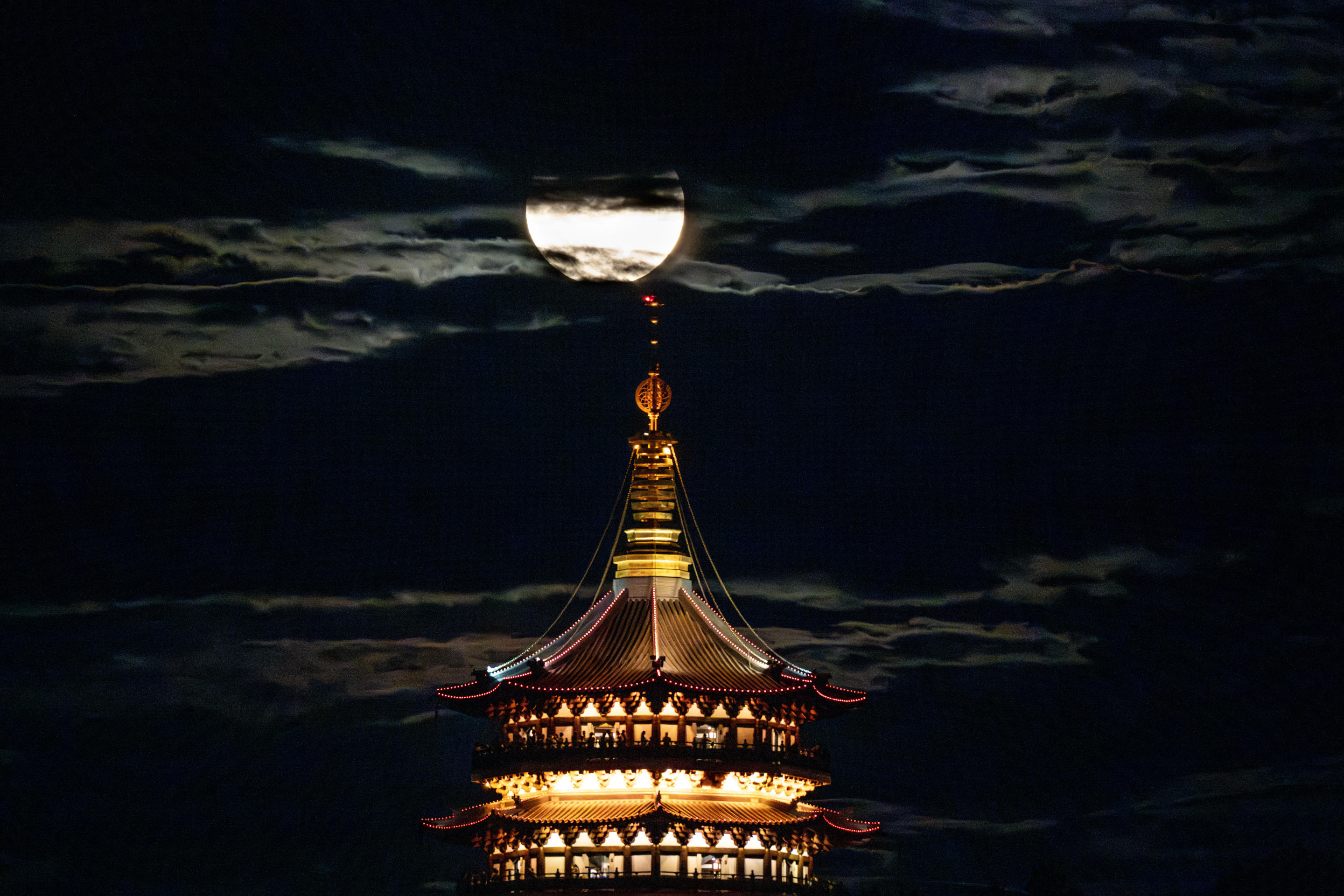 A supermoon will rise over the Leifeng Pagoda in West Lake Sudi in Hangzhou, Zhejiang Province, China, on August 19, 2024. (Xu Yan/Zhejiang Daily Press Group/VCG via Getty Images)