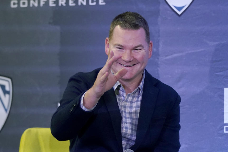 FILE - In this Oct. 13, 2021, file photo, Arizona coach Tommy Lloyd waves while speaking during the Pac-12 Conference men's NCAA college basketball media day in San Francisco. Lloyd became a head coach for the first time when Arizona hired him to replace Sean Miller in the hopes he can rebuild the Wildcats into an elite program. (AP Photo/Jeff Chiu, File)