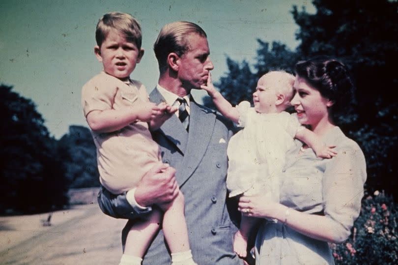 Then Princess Elizabeth and Prince Philip holding Prince Charles and Princess Anne