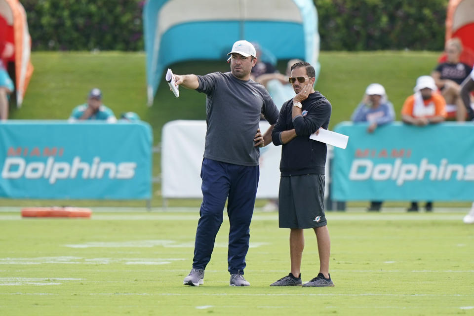 Miami Dolphins head coach Mike McDaniel, right, talks with Frank Smith, offensive coordinator, during drills at the NFL football team’s practice facility, Saturday, Aug. 6, 2022, in Miami Gardens, Fla. (AP Photo/Wilfredo Lee)
