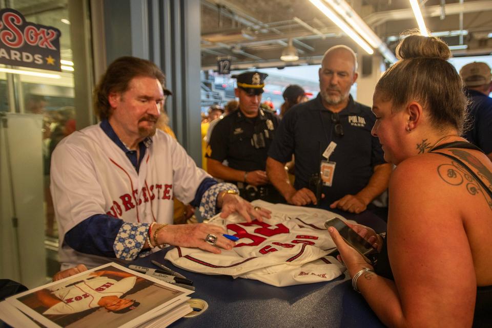 Red Sox legend Wade Boggs signs a jersey for Tina DelleChiaie of Dudley at Polar Park on Thursday.