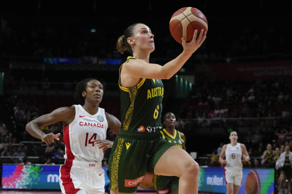 Australia's Steph Talbot lays up to score goal as Canada's Kayla Alexander, left, watches during their game at the women's Basketball World Cup in Sydney, Australia, Monday, Sept. 26, 2022. (AP Photo/Mark Baker)