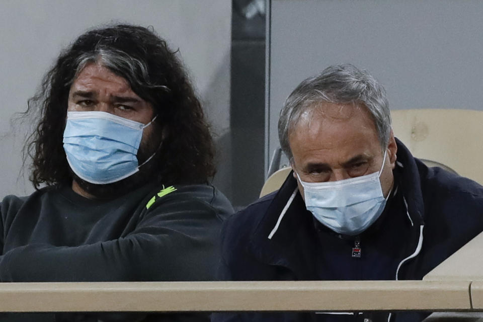 Alexander Kenin, father of Sofia Kenin of the U.S., right, and Emmanuel Planque, coach of France's Fiona Ferro, left, watch the fourth round match of the French Open tennis tournament between Kenin and Ferro at the Roland Garros stadium in Paris, France, Monday, Oct. 5, 2020. (AP Photo/Alessandra Tarantino)