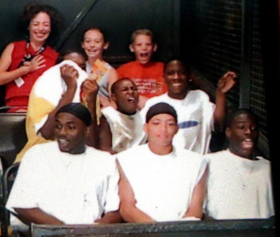 David Crowley, bottom right, is pictured on a Disney World ride when he and other teens from Milwaukee were taken to the park by Ken Swan as a reward for their work at his lawn maintenance business. The business owner along with being a mentor, taught Crowley work ethic during his time with him.