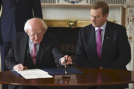 President Michael D. Higgins prepares to sign Prime Minister Enda Kenny's (R) Seal of Government to office of Taoiseach in Dublin, Ireland May 6, 2016. REUTERS/Clodagh Kilcoyne