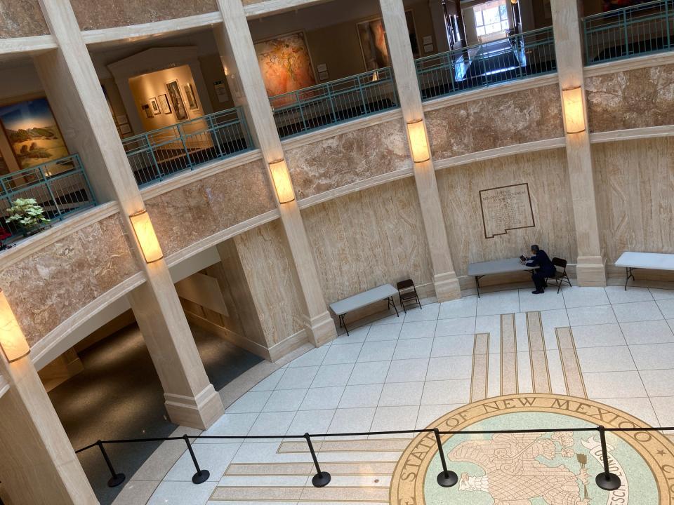 A lawmaker works inside the state Capitol rotunda in Santa Fe, N.M., in 2021.