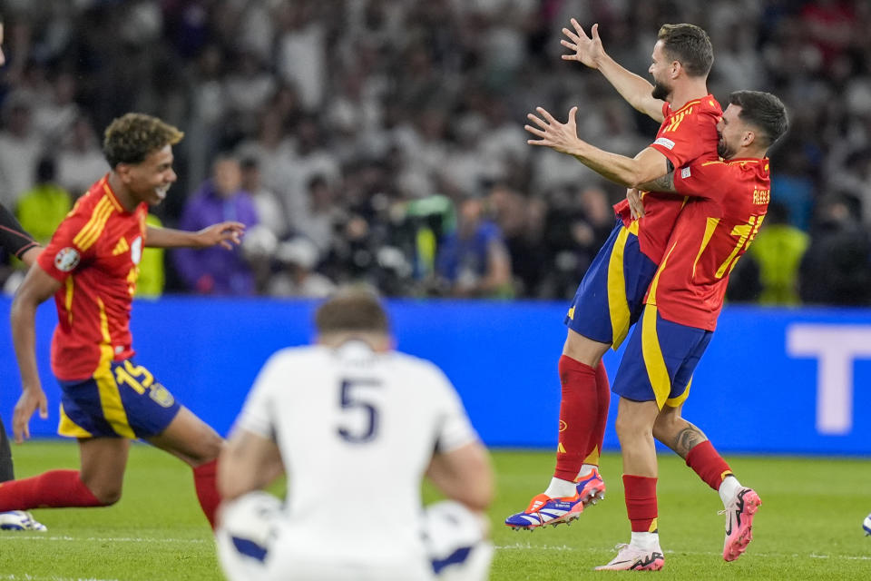 Spain players celebrate after winning the final match between Spain and England at the Euro 2024 soccer tournament in Berlin, Germany, Sunday, July 14, 2024. (AP Photo/Matthias Schrader)