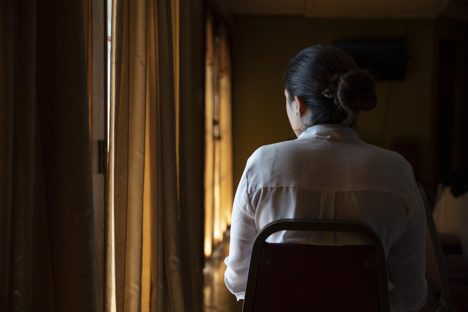 A woman deported from the United States in August 2019 poses for a photo in San Pedro Sula, Honduras, on Nov. 28, 2019. Before she and her husband left for the U.S., the young couple had opened a tiny grocery store in the Rivera Hernandez neighborhood of the city. After a few months, they were forced to start paying "war tax" to the Mara 18 gang. The amounts rose and rose until they couldn't pay anymore. Fearing for their lives, they fled to the safest place they could think of. (AP Photo/Moises Castillo)