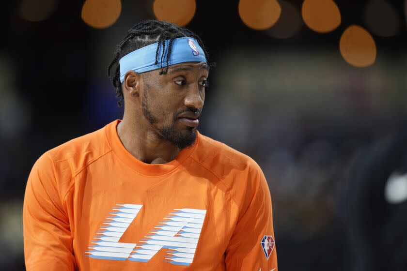 Los Angeles Clippers forward Robert Covington wears an orange Clippers warmup shirt