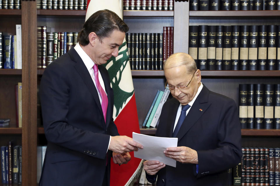 In this photo released by Lebanon's official government photographer Dalati Nohra, Lebanese President Michel Aoun, right, receives from U.S. Envoy for Energy Affairs Amos Hochstein, the U.S.-brokered deal setting a maritime border between Lebanon and Israel, at the presidential palace, in Beirut, Lebanon, Thursday, Oct. 27, 2022. Lebanon signed and delivered its copy of a U.S.-mediated sea border deal with Israel on Thursday to a U.S. mediator, hoping to soon start exploring gas in its southern maritime blocs to bring economic stability to the crisis-ridden country. (Dalati Nohra via AP)