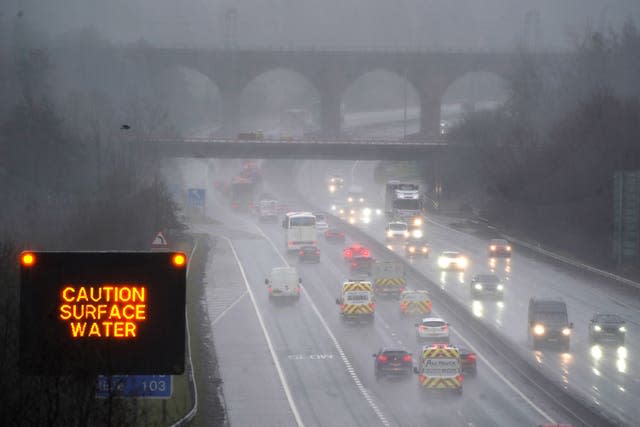 Vehicles make their way through heavy rain on a motorway 