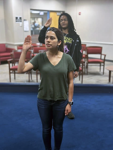 Esmita Spudes Bidari raises swears the oath to join the U.S. Army Reserves on June 7, 2023. When Bidari was a young girl in Nepal, she dreamed of being in the military, but that wasn't a real option in her country. Bidari, who heads to basic training in August, is just the latest in a growing number of legal migrants enlisting in the U.S. military as it more aggressively seeks out immigrants, offering a fast track to citizenship to those who sign up. (Sgt. 1st Class Derrick Jacobs/U.S. Army via AP)