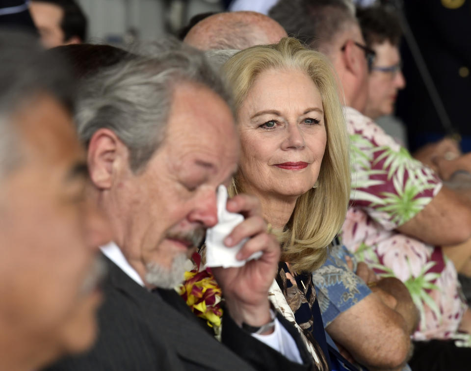 Diana Brown Sanfilippo right, who has spent a lifetime searching for her father, 1st Lt. Frank Salazar who died 66 years ago in North Korea, attends a ceremony marking the arrival of the remains believed to be of American service members who fell in the Korean War at Joint Base Pearl Harbor-Hickam, Hawaii, Wednesday, Aug. 1, 2018. Wiping his eyes at left is Rick Downes, who was three when his father Hal went off to the Korean War, and has been missing ever since. (AP Photo/Susan Walsh)