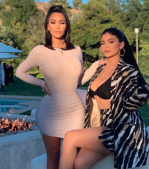 Kim and Kylie posing in dresses