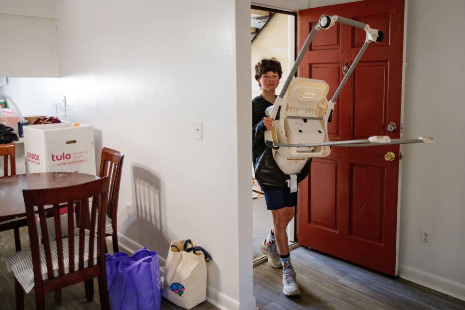 Volunteers from Killearn United Methodist Church bring in furniture to turn an apartment into a home for a family of Afghan refugees Saturday, Jan. 8, 2022.