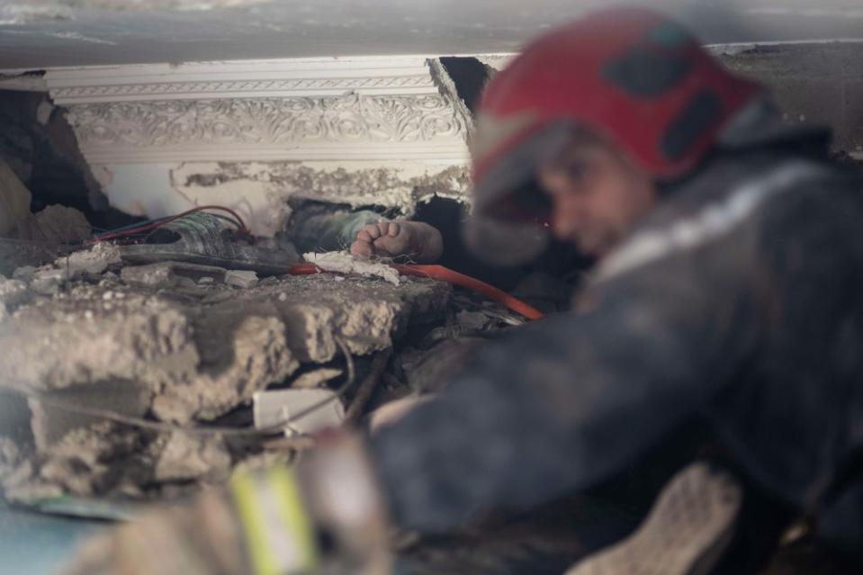 The foot of a man stuck under rubble while a rescue operation for him is underway after an earthquake in Moulay Brahim village, near Marrakech, on Sept. 9.<span class="copyright">Mosa'ab Elshamy—AP</span>