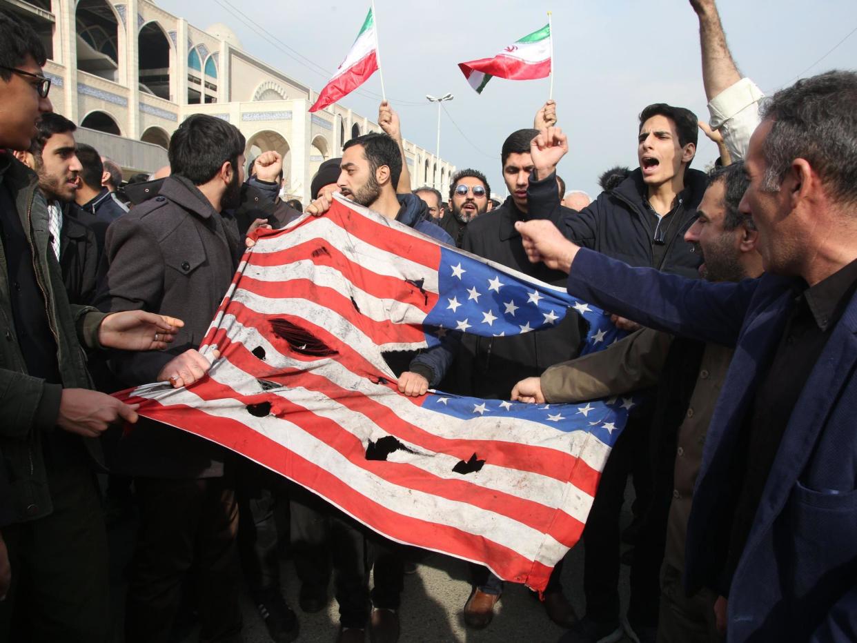 Iranians tear up a US flag during a demonstration in Tehran: AFP/Getty