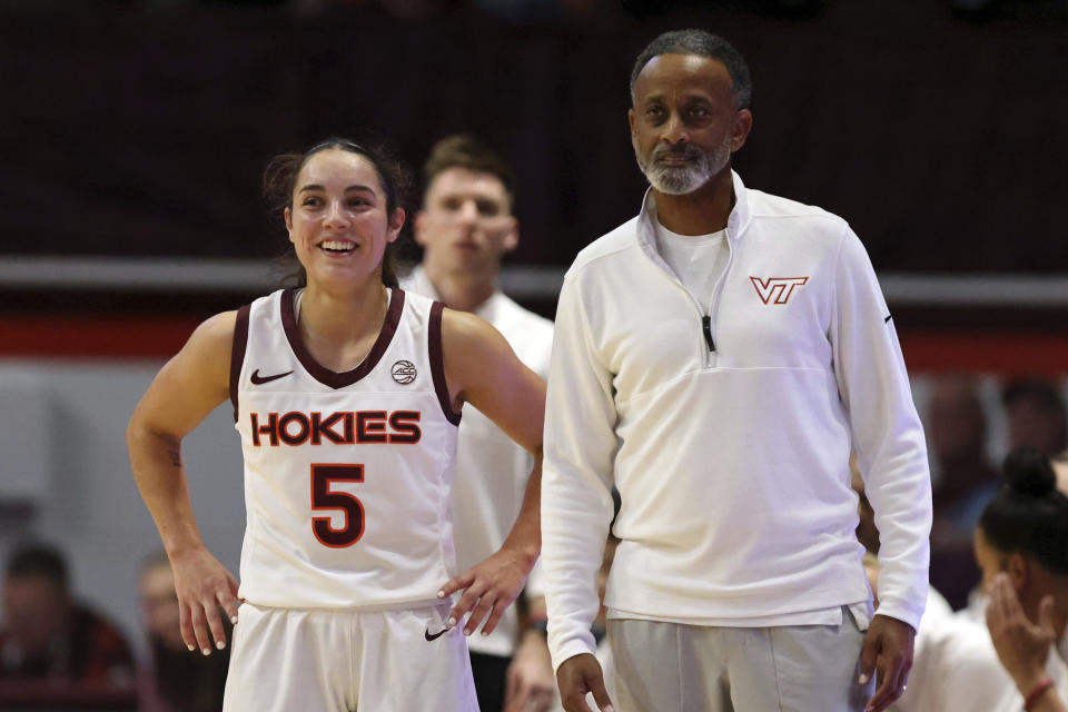 Virginia Tech's Georgia Amoore (5) and head coach Kenny Brooks, right, look on in the first half of an NCAA college basketball game against High Point in Blacksburg, Va., Monday, Nov. 6, 2023. (Matt Gentry/The Roanoke Times via AP)