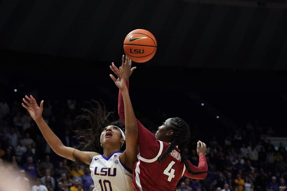 LSU forward Angel Reese (10) and Arkansas forward Erynn Barnum (4) battle under the basket in the second half an NCAA college basketball game in Baton Rouge, La., Thursday, Jan. 19, 2023. LSU won 79-76. (AP Photo/Gerald Herbert)