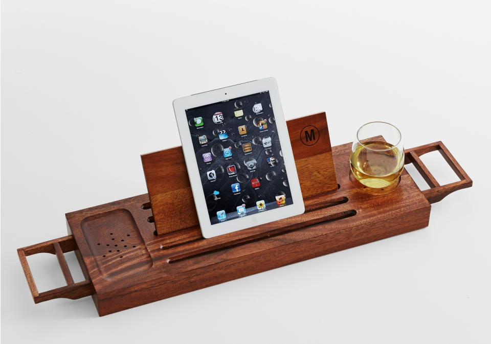This photo provided by RedEnvelope shows a monogrammed acacia wood bath caddy, with space for a beverage, phone and e-reader or book, that would be a thoughtful gift for moms who enjoy "me" time in the bathtub. (AP Photo/Copyright RedEnvelope)