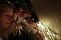 <p>Locals place candles outside the Polytechnic School during a vigil in Rosario, Argentina, Wednesday, Nov. 1, 2017. (Photo: Natacha Pisarenko/AP) </p>