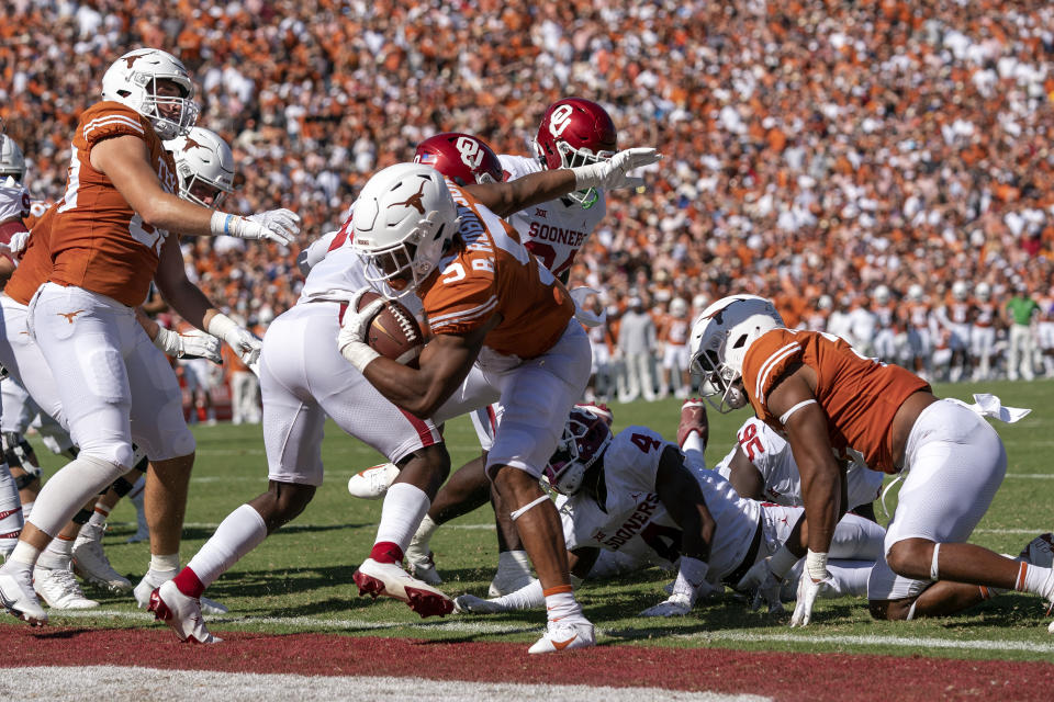 Texas running back Bijan Robinson (5) steps into the end zone against Oklahoma during the first half of an NCAA college football game at the Cotton Bowl, Saturday, Oct. 9, 2021, in Dallas. (AP Photo/Jeffrey McWhorter)