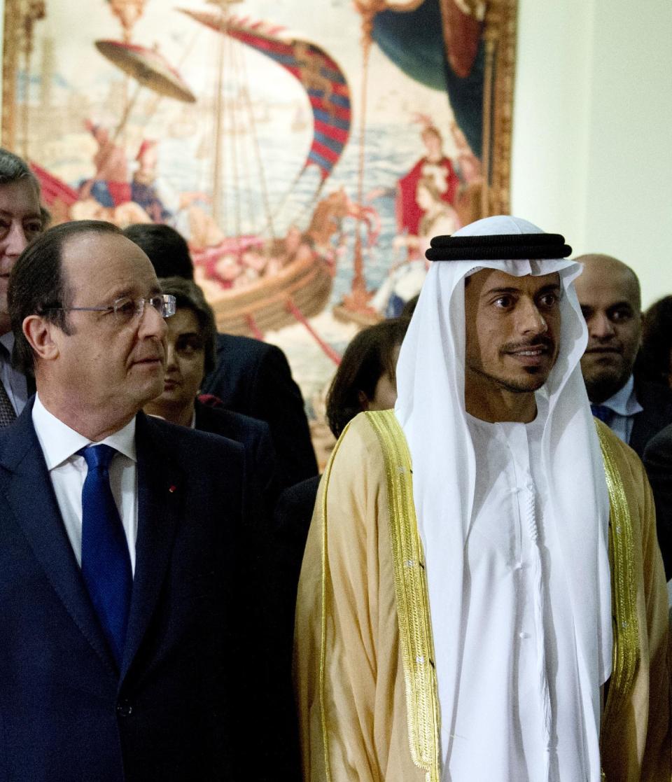 French President Francois Hollande, left, and Sheikh Sultan Bin Tahnoon Al Nathyan, Abu Dhabi authority president for tourism and culture, visit the exhibition 'Birth of a Museum', at the Louvre museum, Tuesday April 29, 2014, in Paris. The 'Birth of a Museum' exposition presents paintings, sculptures, and other artworks that the famous French Louvre museum will send to the new Louvre museum branch in Abu Dhabi, in the United Arab Emirates, and which is expected to open in 2015. (AP Photo/Alain Jocard, Pool)