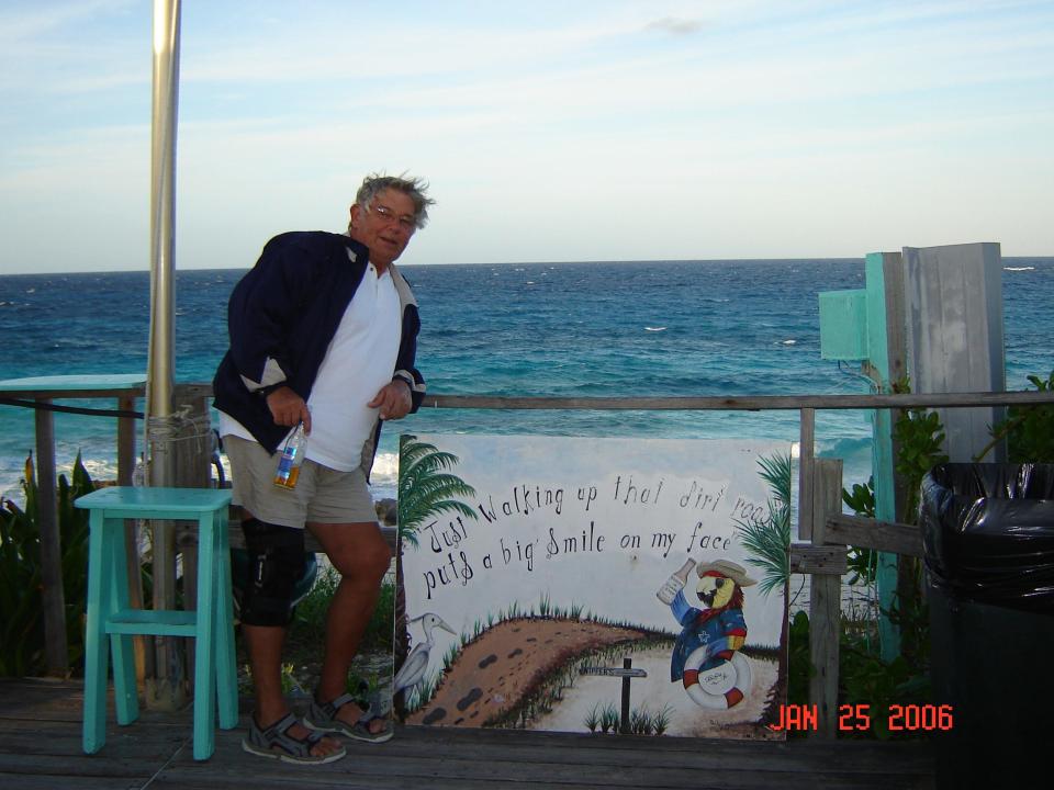 In this 2006 photo, Kent Trompeter, a Peoria native, stands near a sign in Hopetown in the Bahamas. He recently finished his four-year degree at the age of 78 and will begin teaching in high school this fall.