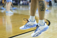 North Carolina guard R.J. Davis (4) with a tatoo of Malcom X warms up during practice for the men's Final Four NCAA college basketball tournament, Friday, April 1, 2022, in New Orleans. (AP Photo/Brynn Anderson)